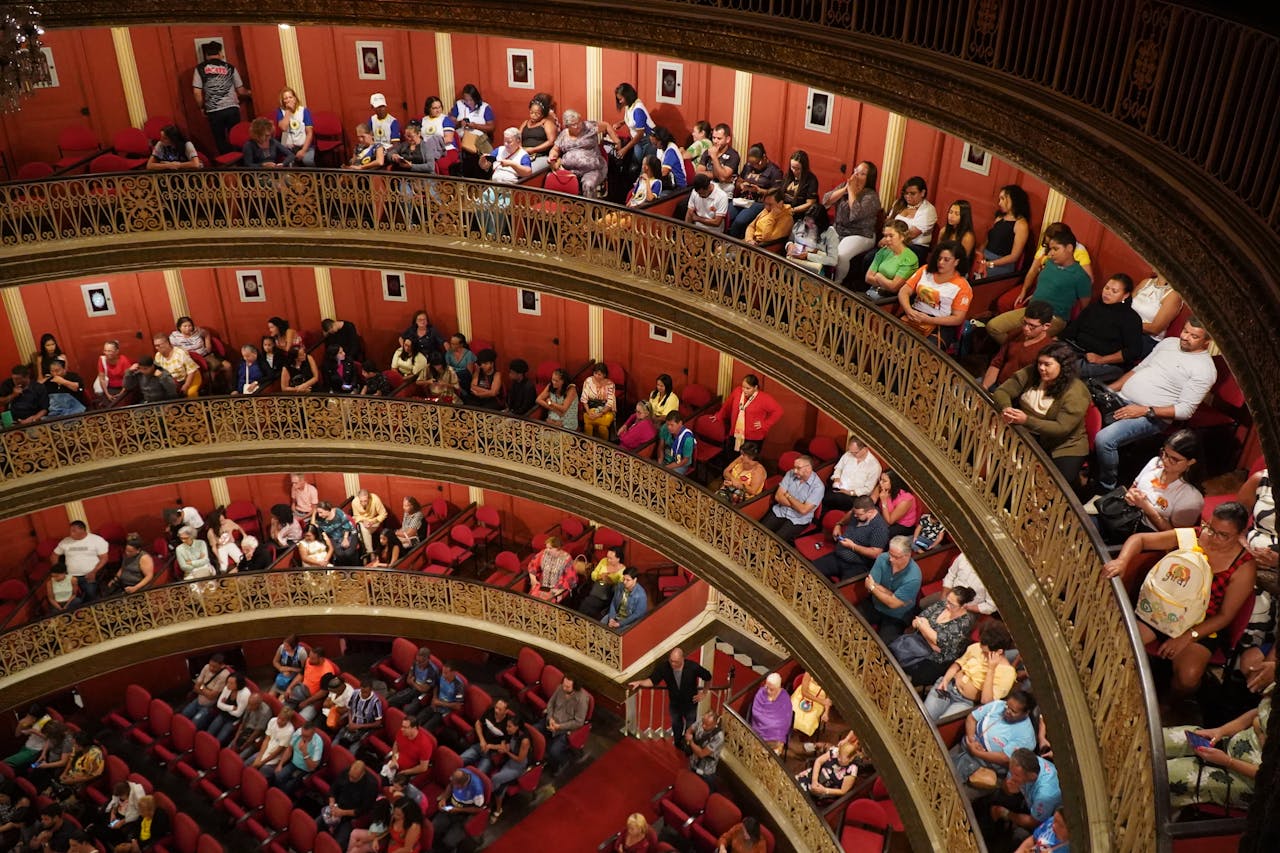 services-04 View of audience in Teatro Santa Isabel, Recife, showcasing its elegant architecture and engaged spectators.