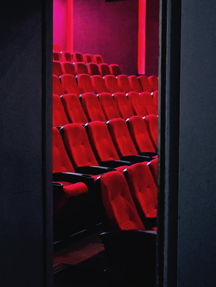 services-03 A view of empty red theater seats in a dimly lit cinema in Tehran, Iran.